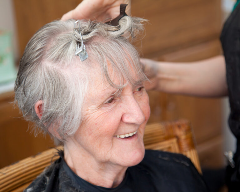 A senior woman getting her hair done